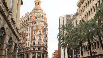 Street lined with Spanish style buildings and palm trees