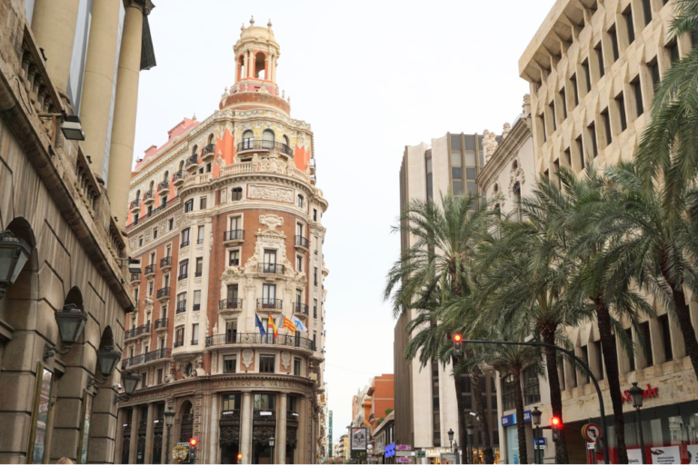 Street lined with Spanish style buildings and palm trees