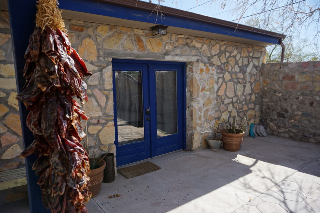 Stone El Paso Texas casita with dried chilis hanging in foreground