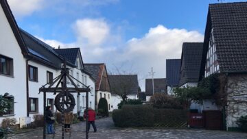 Small town center of Neuenrade Germany with cobblestones and a water well