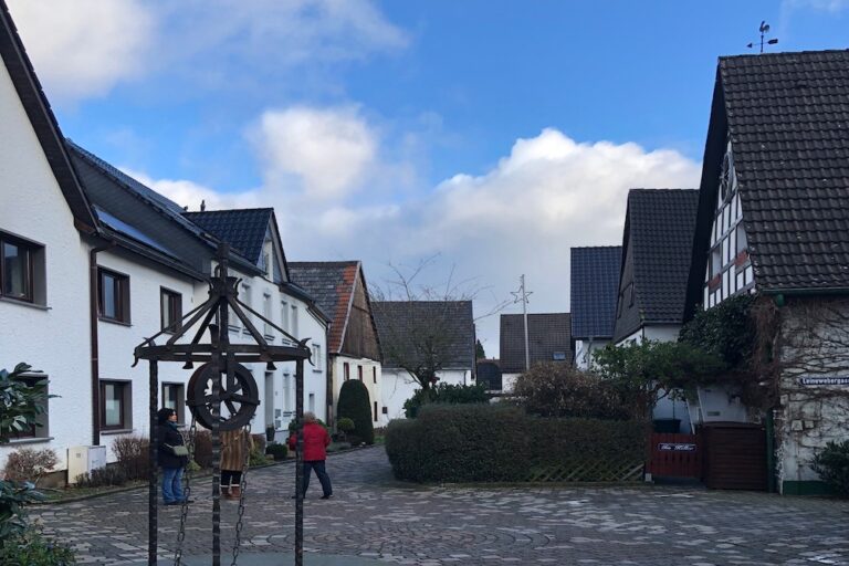 Small town center of Neuenrade Germany with cobblestones and a water well