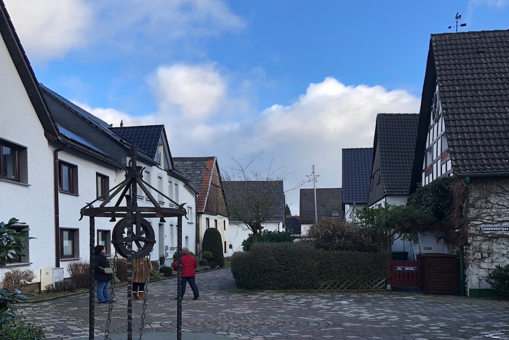 Small town center of Neuenrade Germany with cobblestones and a water well