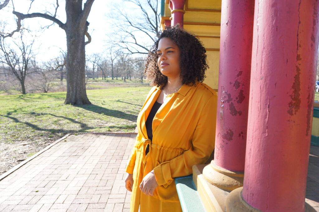 Woman in yellow jacket in a colorful Baltimore city park pagoda