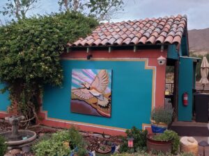 Colorfully painted cabana with Mediterranean-style roof tiles and a painting of an eagle in New Mexico