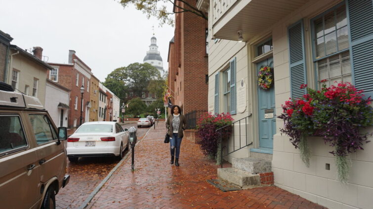 Woman walking down brick street in Annapolis Maryland
