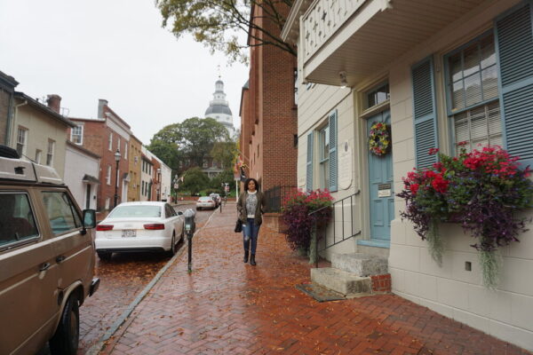 Woman walking down brick street in Annapolis Maryland