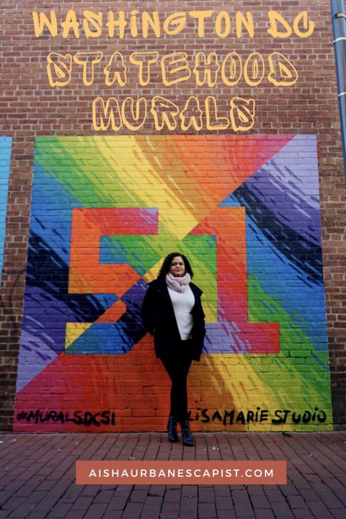 Woman standing in front of colorful mural with the number 51