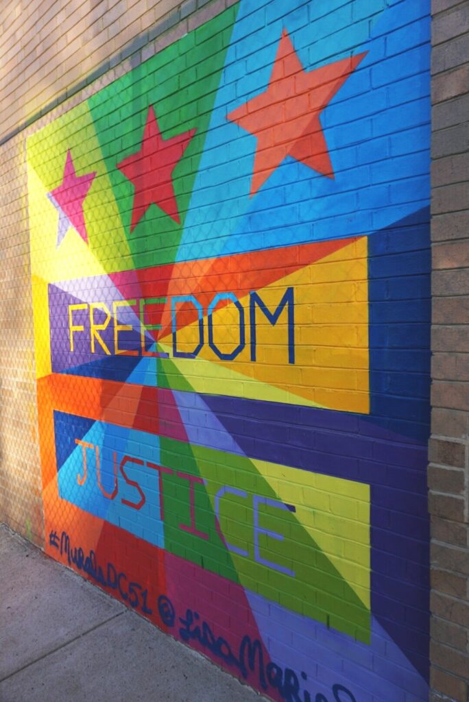 Colorful Washington DC street mural with the words Freedom and Justice