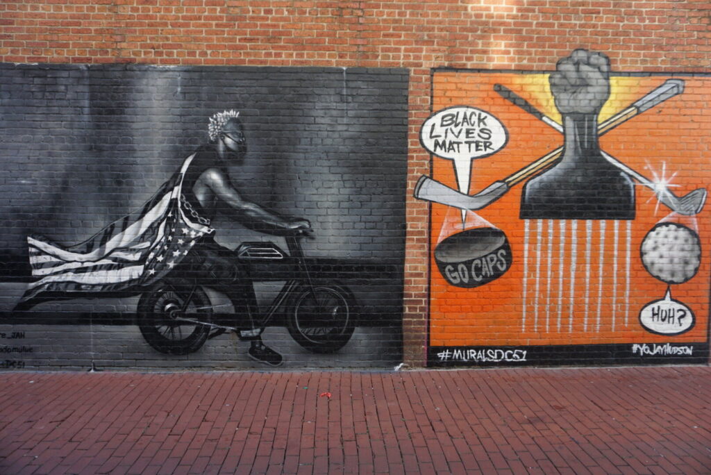 One orange and one black and white Washington DC street mural