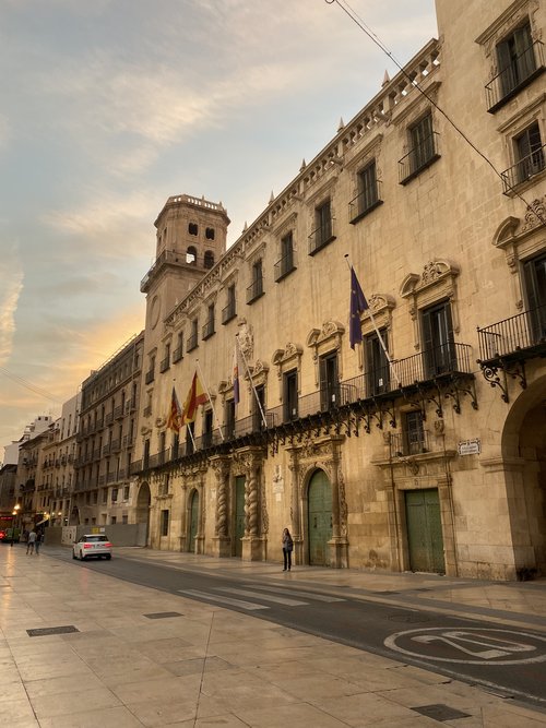 View of the Alicante Spain Town Hall building while the sun is setting.