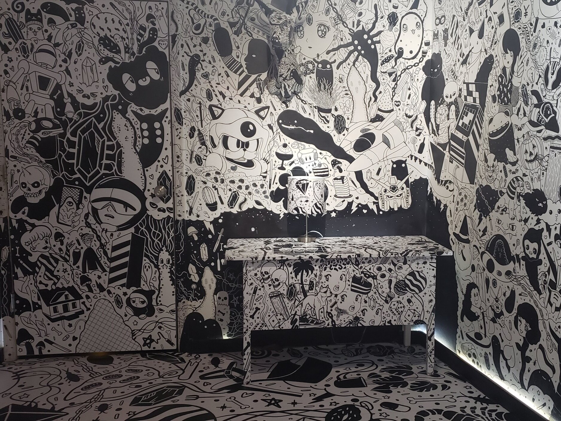 Walls of an art exhibit with black and white cartoon art