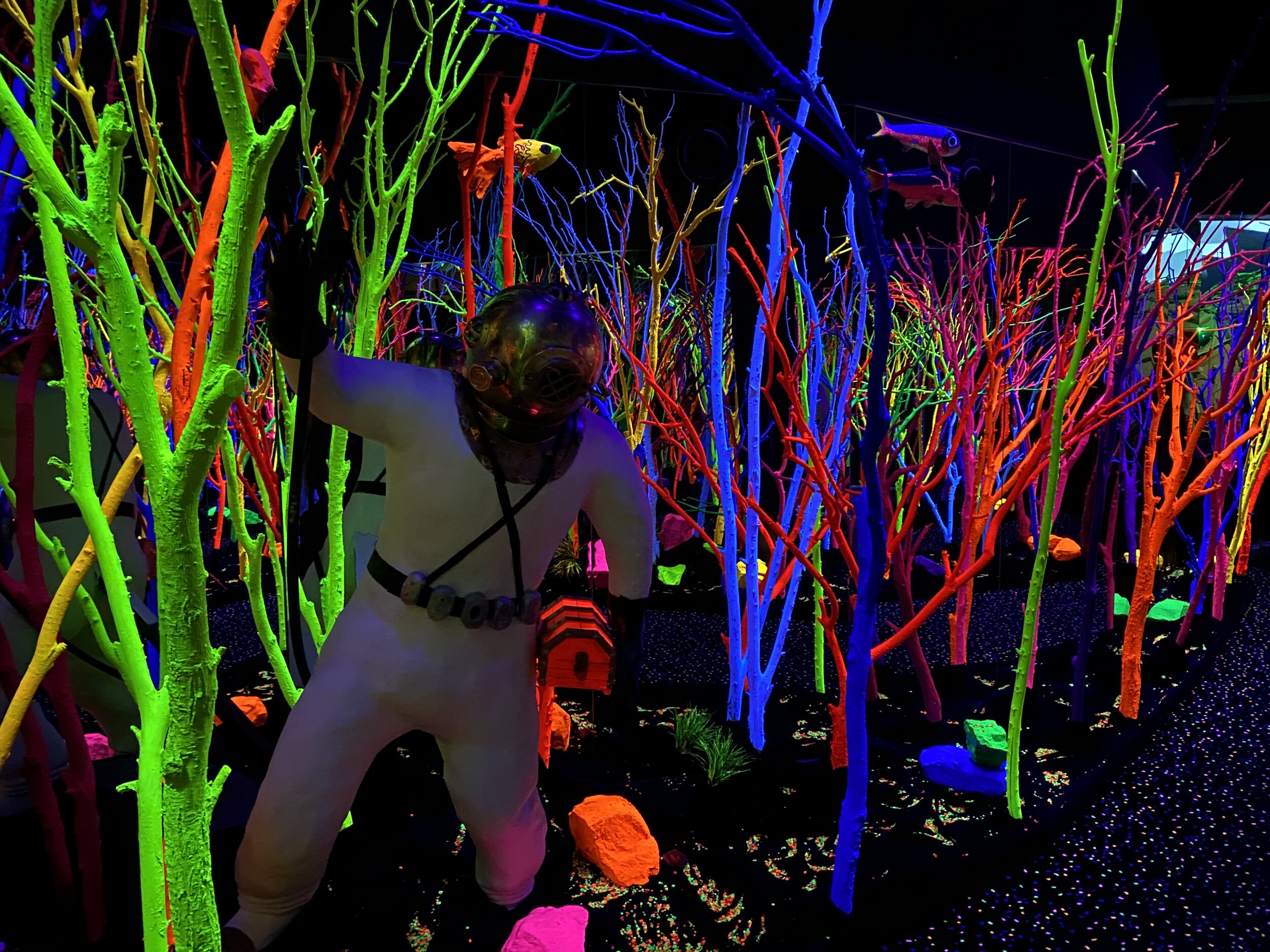 Neon art exhibit with multicolored fluorescent trees