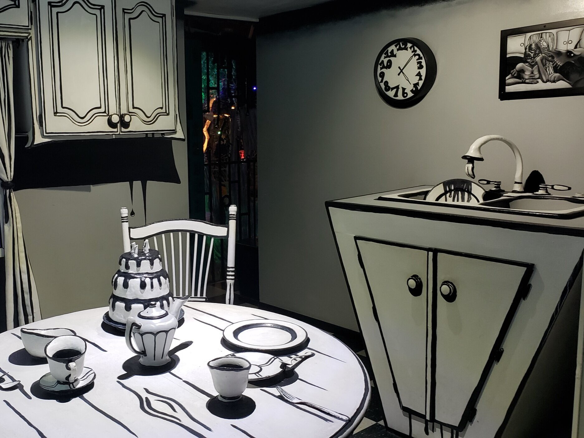 Art exhibit showing a kitchen designed in all black and white