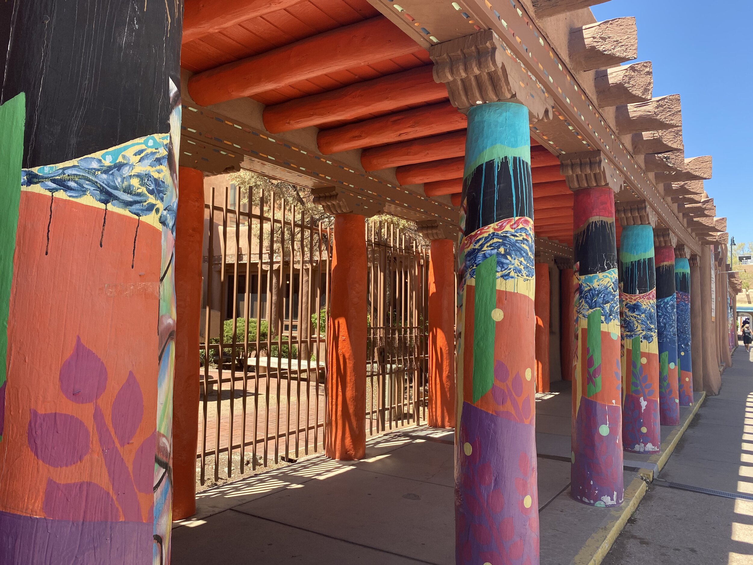 Colorfully painted pillars on a museum building in Santa Fe, New Mexico
