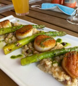 Plate of sea scallops with asparagus and risotto in an Annapolis Maryland restaurant