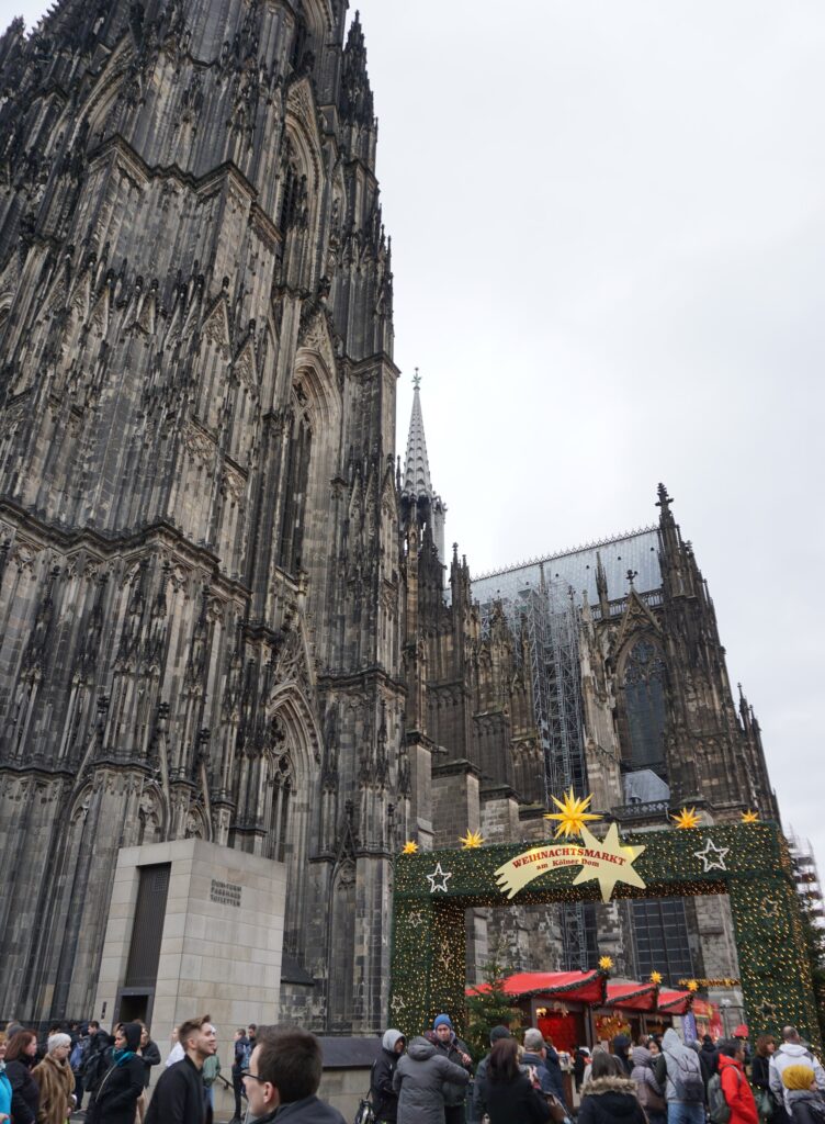 View of the Cologne Cathedral towering above the Christmas market