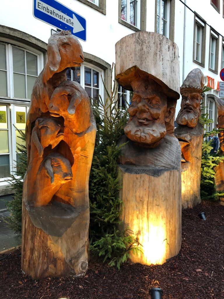 Wooden carved gnome sculptures on display at a German Christmas market