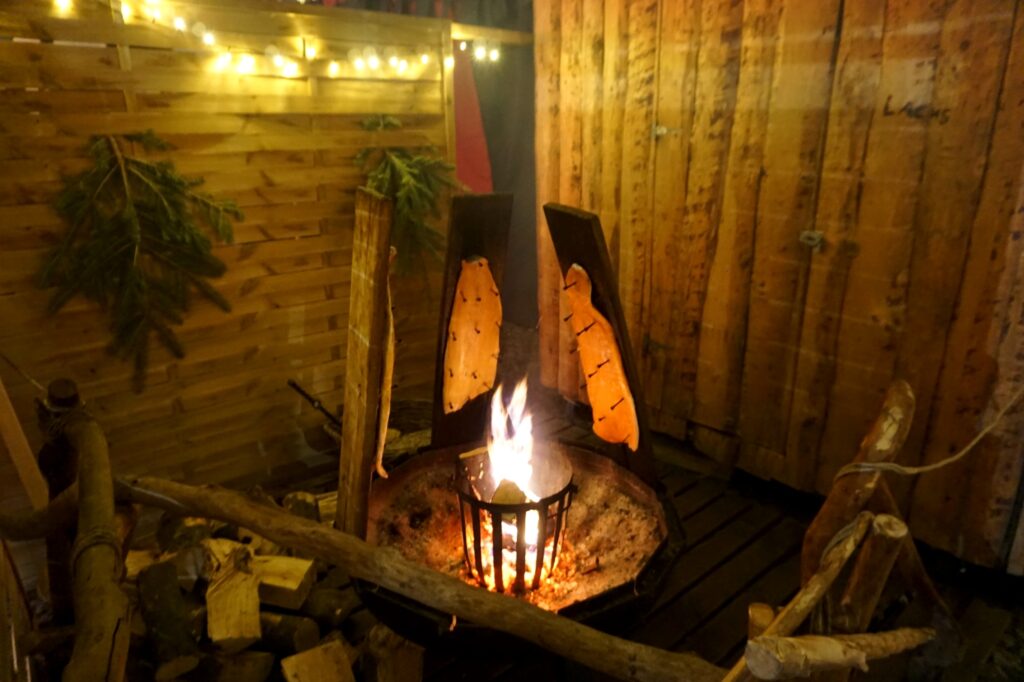 Two salmon fillets over an open fire at a German Christmas market