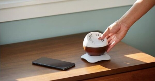 Core self-care app device on a countertop with a cell phone beside it