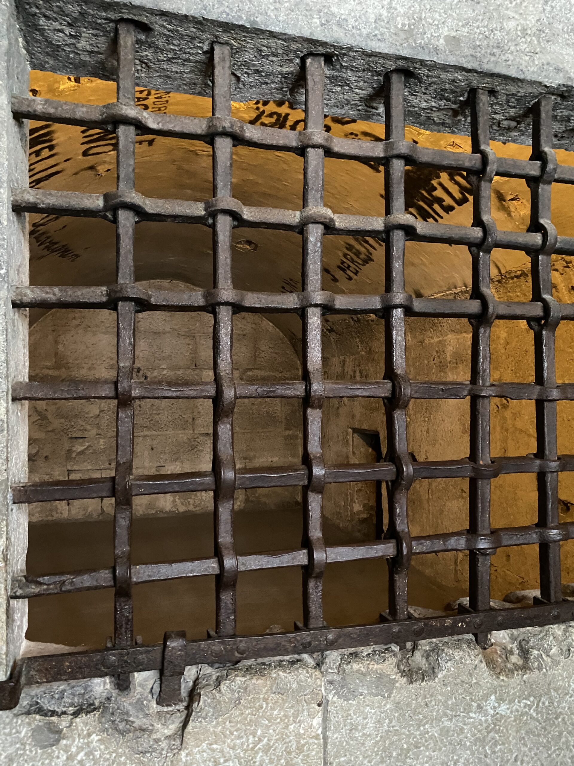Stone prison cell through bars in Venice Italy's Doge's Palace