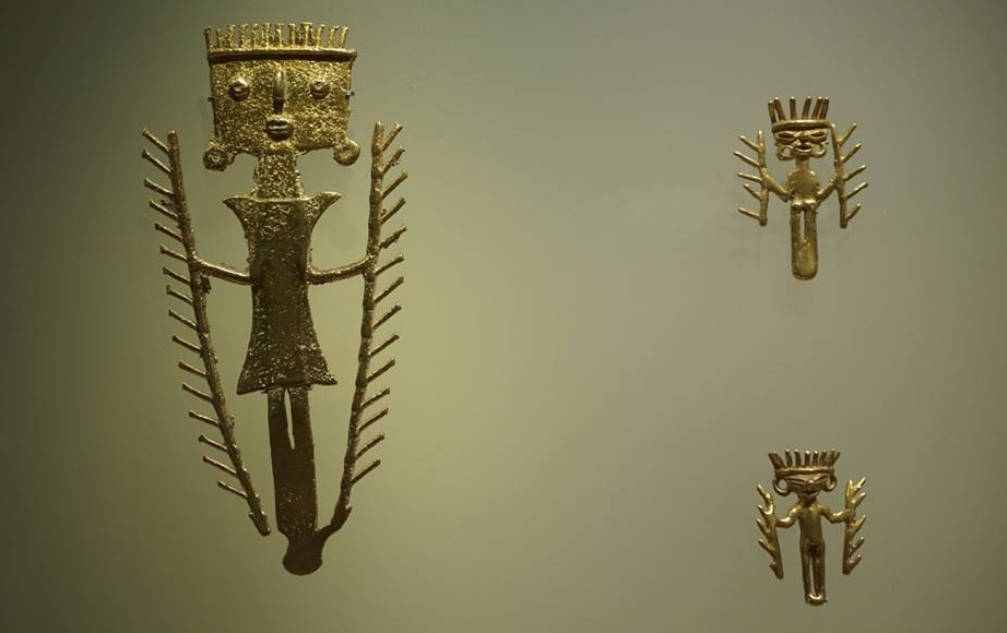 Gold pre-Columbian shaman figurines in a Bogotá Colombia museum display