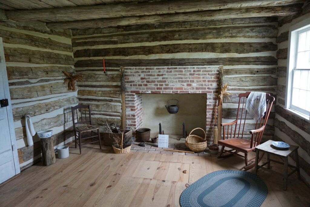 Interior of a historic log cabin with furniture of the time