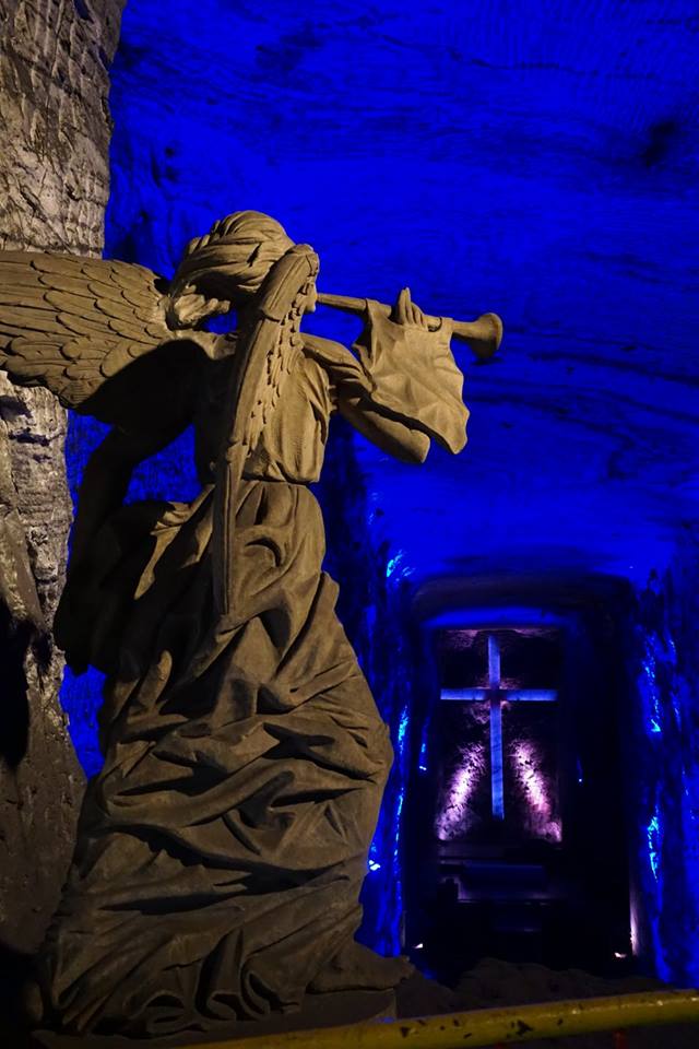 Statue of an angel blowing a horn with a large cross and chapel in Colombia's Zipaquirá Salt Mine