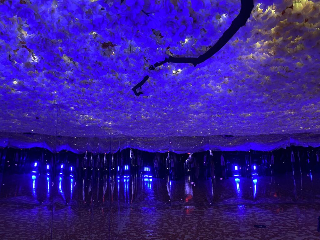 Art exhibition with decorated ceiling and blue and purple lights