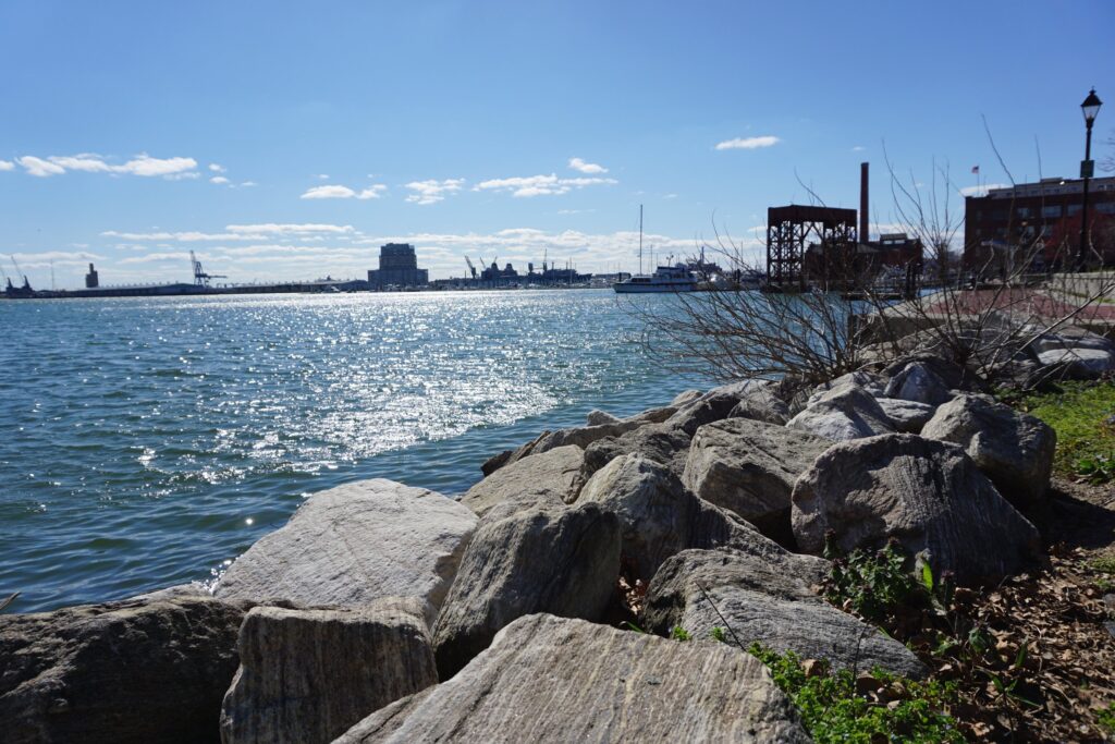 View of the Baltimore Maryland Harbor with rocks on the bank
