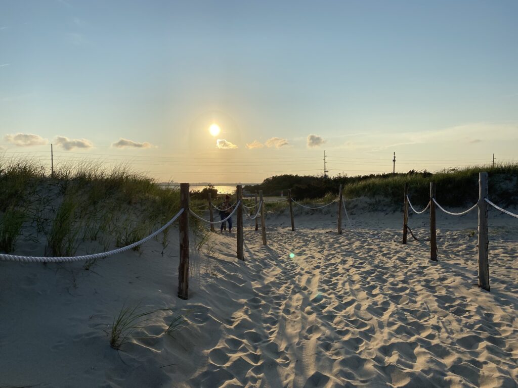 Pathway between sand dunes on a Fenwick Island Delaware beach during sunset
