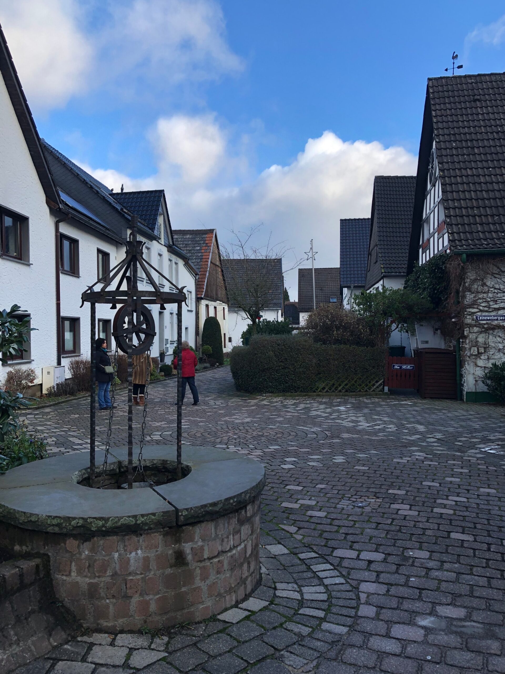 Small town square of Neuenrade Germany with cobblestone ground and a well