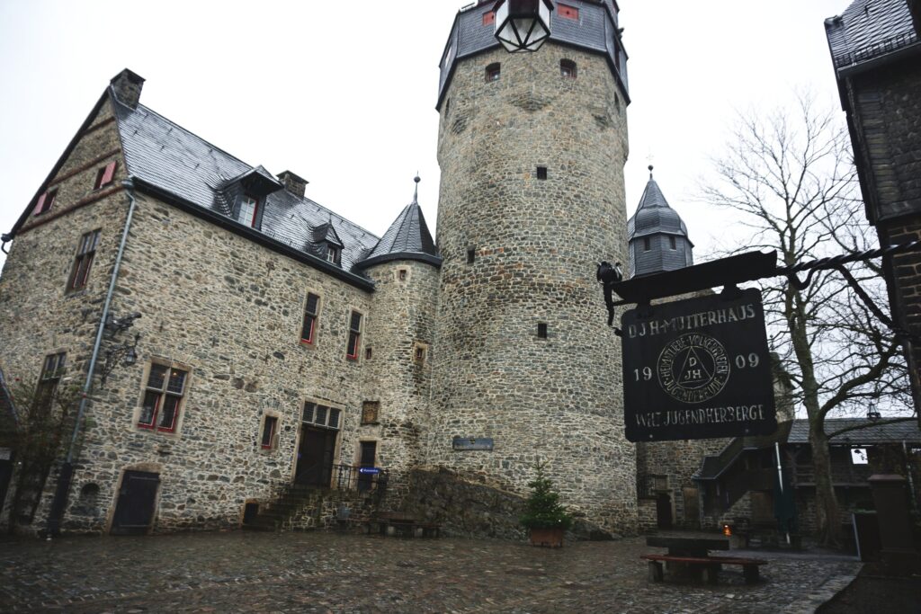 Old castle and sign for the world's first youth hostel in Altena Germany