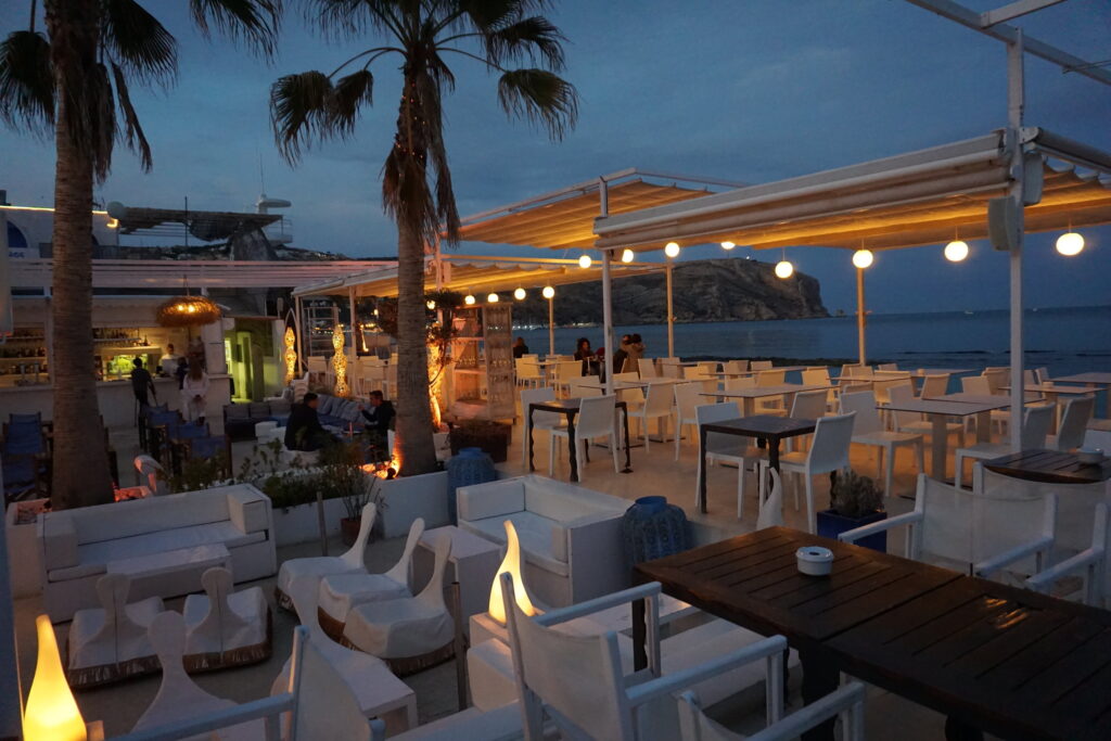 White chairs and couches on an outdoor restaurant patio in Javea Spain