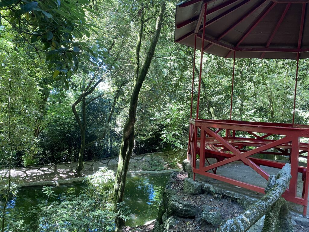 Wooded park with lake and red gazebo
