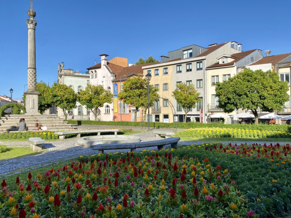 Plaza with a row of buildings and flower garden