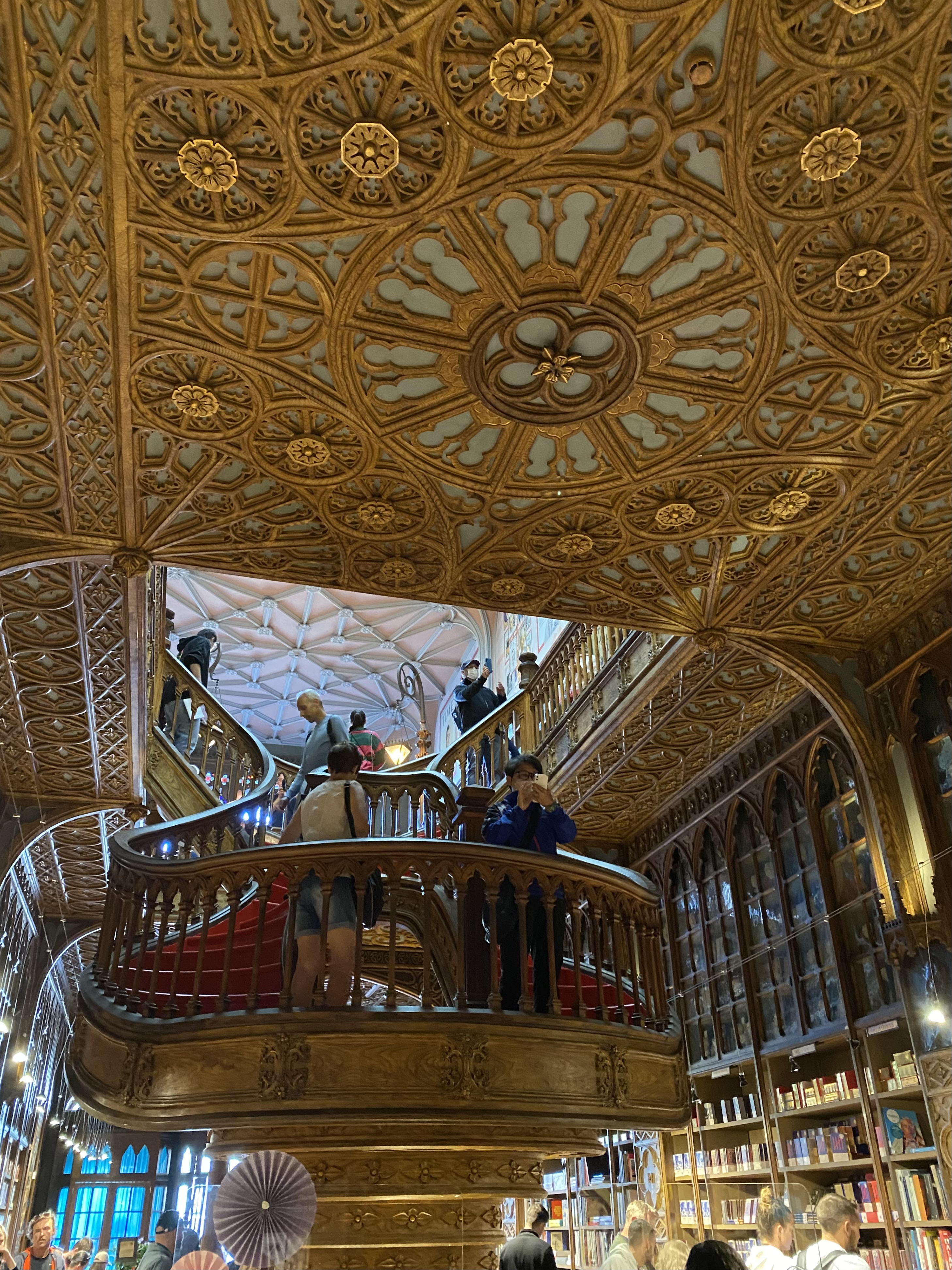 Gold detail on ornate ceiling and curved staircase in a Porto bookstore