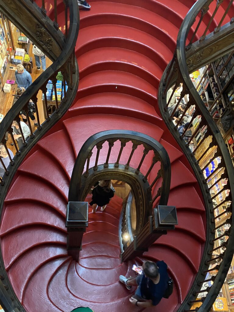Red symmetrical spiral staircase in a bookstore in Porto Portugal