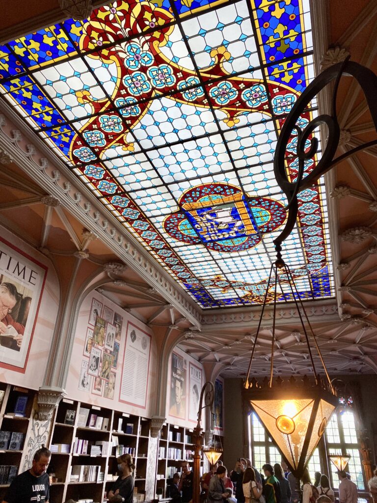 Stained glass ceiling and architectural details on ceiling and walls of Lello Bookstore in Porto Portugal