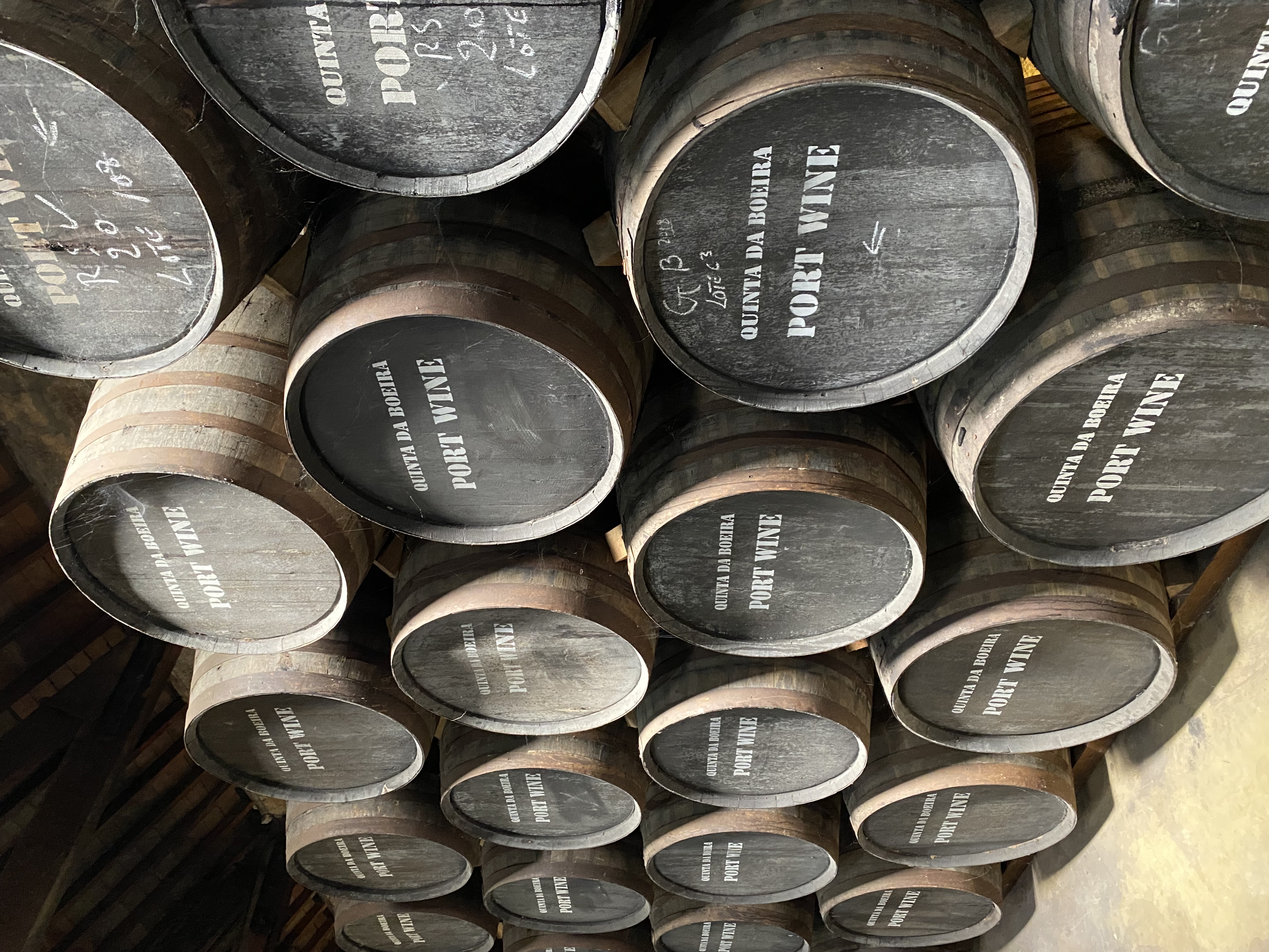 Stacked barrels of port wine in a wine cellar