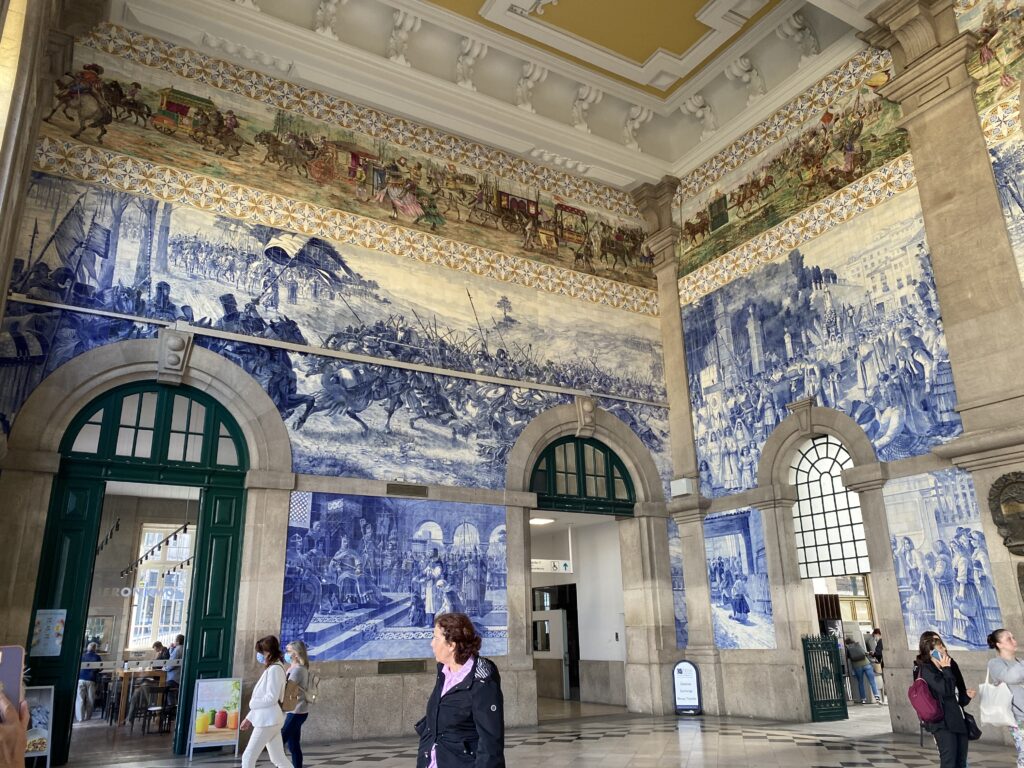 Tile mural art on the wall of Sao Bento train station lobby in Porto Portugal