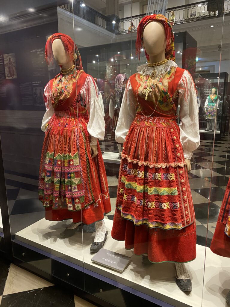 Two museum mannequins dressed in traditional northern Portugal blouse, skirt, gold filigree jewelry, and red scarf