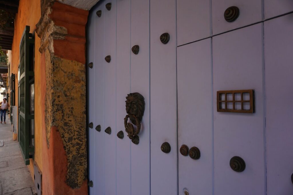 Spanish-style white double door with lion door knocker in old town Cartagena Colombia