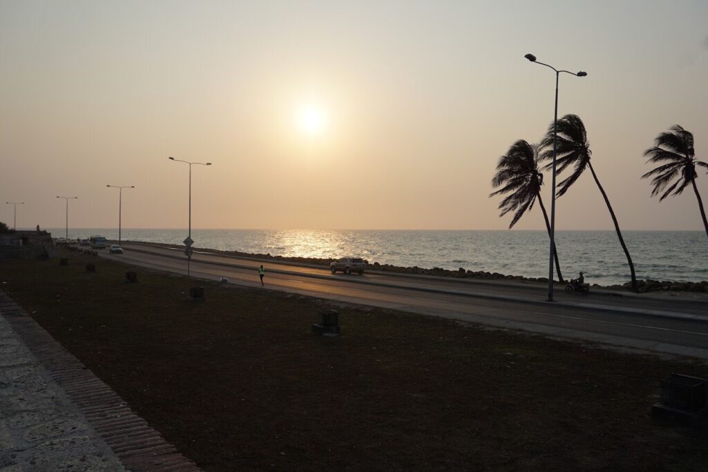 Sunset over the ocean beyond a road in Cartagena Colombia