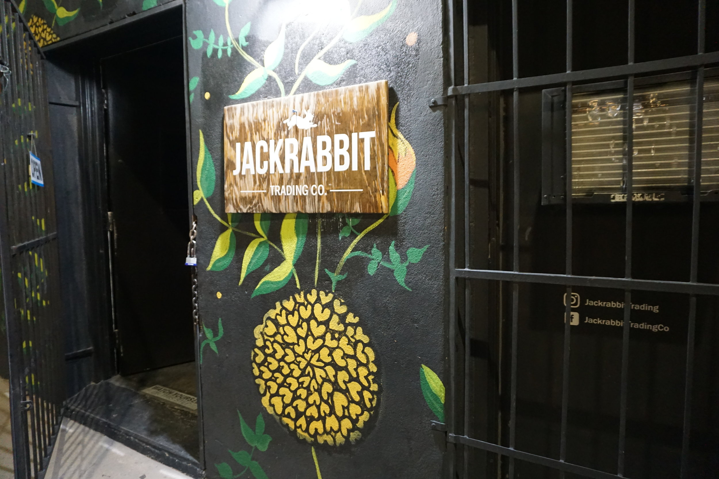 Storefront with a wooden sign that says Jackrabbit