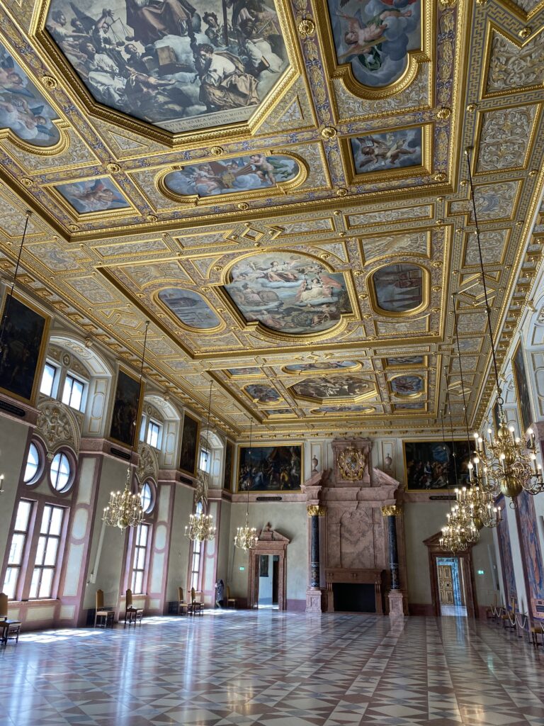 Munich Residence palace hall with golden and painted ceilings and chandeliers