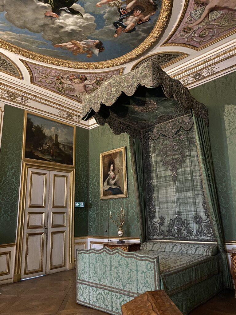 Royal bedroom in a Munich Bavarian palace with green velvet decor and painted ceiling