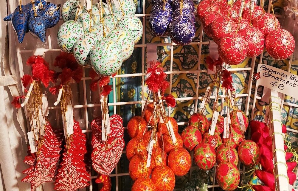 Hanging display of Christmas ornaments at a holiday market