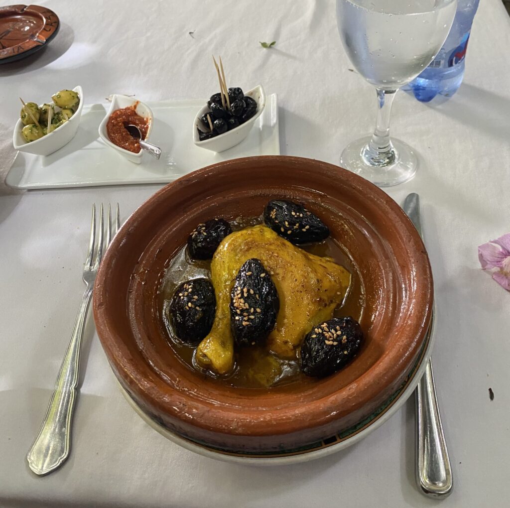Plate of Moroccan chicken with dried prunes on a restaurant table