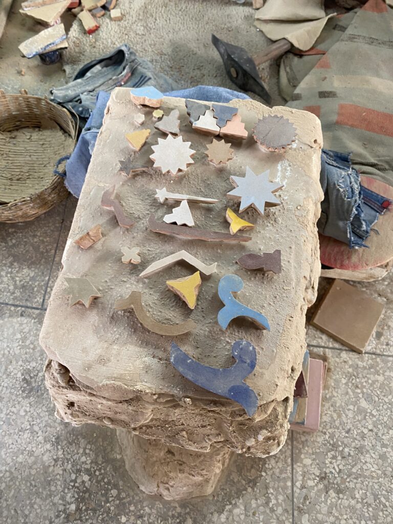Stone work slab with individual colored tiles in a Fez Morocco pottery studio