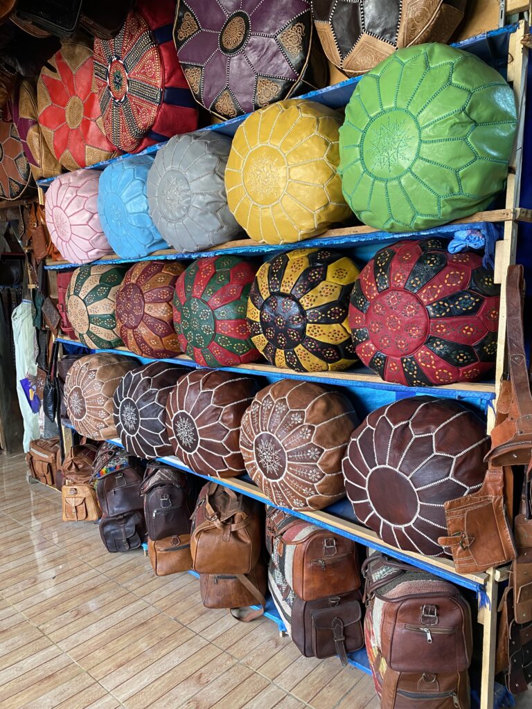 Wall display of leather Moroccan ottomans on shelves